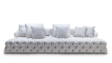 White tufted velvet sofa with decorative pillows showcasing the Versailles Sofa style